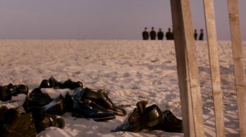 Movie still from “The Normal Heart” (2014), directed by Ryan Murphy – Several pairs of shoes on the sand of a beach; Wide shot, High angle
