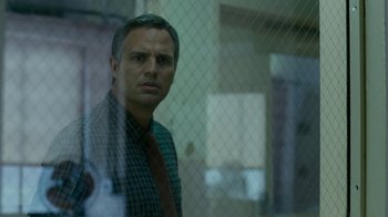 Movie still from “The Normal Heart” (2014), directed by Ryan Murphy – A man standing in front of a fence looking at the camera; Close Up shot, Over the shoulder angle