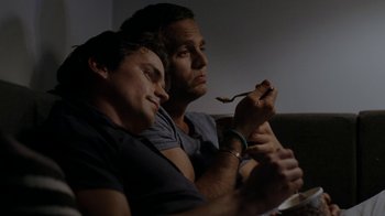 Movie still from “The Normal Heart” (2014), directed by Ryan Murphy – A couple of men sitting next to each other on top of a couch; Medium shot, Overhead angle