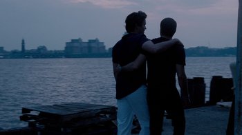 Movie still from “The Normal Heart” (2014), directed by Ryan Murphy – A couple of men standing next to a body of water; Medium shot, Over the shoulder angle