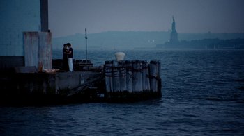 Movie still from “The Normal Heart” (2014), directed by Ryan Murphy – Two people standing on a dock near the water; Extreme Wide shot, High angle