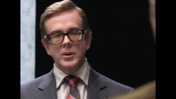 Movie still from “The Normal Heart” (2014), directed by Ryan Murphy – A person wearing a suit and tie; Close Up shot, Over the shoulder angle