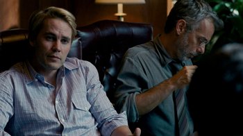Movie still from “The Normal Heart” (2014), directed by Ryan Murphy – Two men sitting in a leather chair in front of each other; Medium shot, Over the shoulder angle