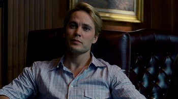 Movie still from “The Normal Heart” (2014), directed by Ryan Murphy – A person sitting in a chair wearing a shirt; Close Up shot, Over the shoulder angle