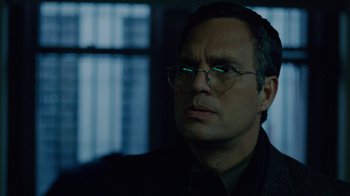 Movie still from “The Normal Heart” (2014), directed by Ryan Murphy – A person wearing glasses and a jacket; Close Up shot, Low angle