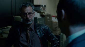 Movie still from “The Normal Heart” (2014), directed by Ryan Murphy – An older man wearing glasses and a leather jacket; Close Up shot, Over the shoulder angle