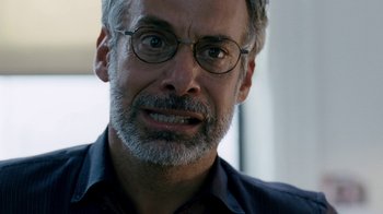 Movie still from “The Normal Heart” (2014), directed by Ryan Murphy – An older man wearing glasses and a black shirt; Close Up shot, Low angle