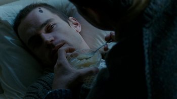 Movie still from “The Normal Heart” (2014), directed by Ryan Murphy – A man eating something while laying in bed; Close Up shot, Overhead angle