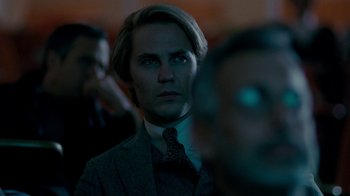 Movie still from “The Normal Heart” (2014), directed by Ryan Murphy – A man in a suit and tie looking at the camera; Close Up shot, Over the shoulder angle