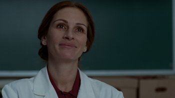Movie still from “The Normal Heart” (2014), directed by Ryan Murphy – A woman in a white lab coat looking up at the sky; Close Up shot, Over the shoulder angle