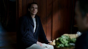 Movie still from “The Normal Heart” (2014), directed by Ryan Murphy – A man sitting at a table with a bowl of broccoli; Medium shot, Over the shoulder angle