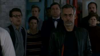 Movie still from “The Normal Heart” (2014), directed by Ryan Murphy – A group of people standing in front of a brick wall; Close Up shot, Over the shoulder angle