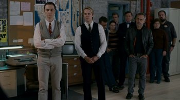 Movie still from “The Normal Heart” (2014), directed by Ryan Murphy – A group of people standing in a room; Medium shot, Over the shoulder angle