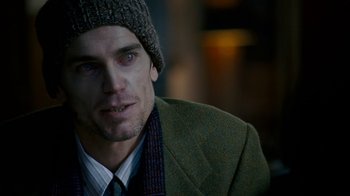 Movie still from “The Normal Heart” (2014), directed by Ryan Murphy – A person wearing a jacket and a hat; Close Up shot, Over the shoulder angle