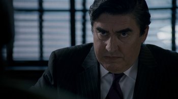 Movie still from “The Normal Heart” (2014), directed by Ryan Murphy – A person wearing a suit and tie; Close Up shot, Over the shoulder angle