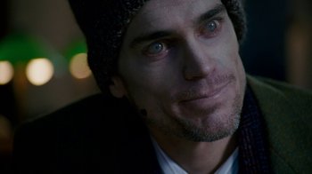 Movie still from “The Normal Heart” (2014), directed by Ryan Murphy – A person wearing a jacket and a hat; Close Up shot, Over the shoulder angle