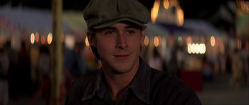 Movie still from “The Notebook” (2004), directed by Nick Cassavetes – A young man wearing a hat and smiling for the camera; Close Up shot, Over the shoulder angle