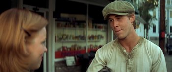 Movie still from “The Notebook” (2004), directed by Nick Cassavetes – A man wearing a hat in front of a store window; Close Up shot, Over the shoulder angle