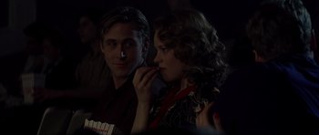 Movie still from “The Notebook” (2004), directed by Nick Cassavetes – A man and a woman sitting next to each other in a dark room; Close Up shot, Over the shoulder angle