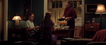 Movie still from “The Notebook” (2004), directed by Nick Cassavetes – Three people sitting at a table in a room; Medium shot, Over the shoulder angle