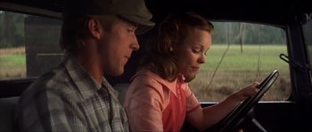 Movie still from “The Notebook” (2004), directed by Nick Cassavetes – A man and a woman sitting in a car looking at a computer screen; Medium shot, Over the shoulder angle