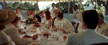 Movie still from “The Notebook” (2004), directed by Nick Cassavetes – A group of people sitting at a table with food; Medium shot, Over the shoulder angle