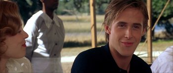 Movie still from “The Notebook” (2004), directed by Nick Cassavetes – A young man smiling while standing next to a person; Close Up shot, Over the shoulder angle