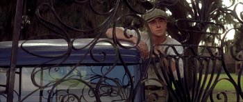 Movie still from “The Notebook” (2004), directed by Nick Cassavetes – A man standing next to a metal fence; Medium shot, Over the shoulder angle