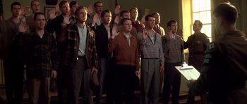 Movie still from “The Notebook” (2004), directed by Nick Cassavetes – A group of men standing in front of each other holding their hands up in the air; Medium shot, Low angle