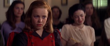 Movie still from “The Notebook” (2004), directed by Nick Cassavetes – A young girl in a red shirt is looking at the camera; Close Up shot, Over the shoulder angle