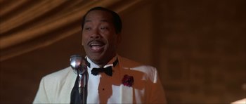 Movie still from “The Notebook” (2004), directed by Nick Cassavetes – A man in a tuxedo is singing into a microphone; Close Up shot, Low angle