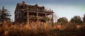 Movie still from “The Notebook” (2004), directed by Nick Cassavetes – An old abandoned house in the middle of a dry grass field; Extreme Wide shot, Low angle