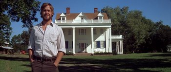 Movie still from “The Notebook” (2004), directed by Nick Cassavetes – A man standing in front of a large white house; Wide shot, Low angle