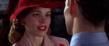 Movie still from “The Notebook” (2004), directed by Nick Cassavetes – A woman wearing a red hat talking to a man in a suit; Close Up shot, Over the shoulder angle
