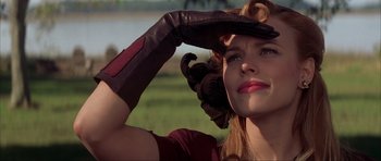 Movie still from “The Notebook” (2004), directed by Nick Cassavetes – A woman wearing a red shirt and a brown leather glove; Close Up shot, Low angle