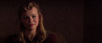Movie still from “The Notebook” (2004), directed by Nick Cassavetes – A woman with blonde hair sitting on a couch; Close Up shot, Over the shoulder angle