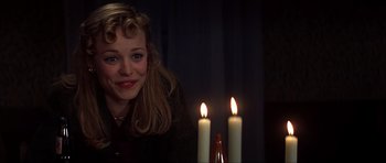 Movie still from “The Notebook” (2004), directed by Nick Cassavetes – A woman sitting in front of two lit candles; Medium shot, Over the shoulder angle