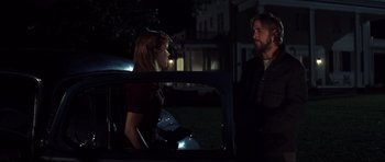 Movie still from “The Notebook” (2004), directed by Nick Cassavetes – A man and a woman standing next to each other in the back of a car; Medium shot, Over the shoulder angle