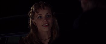 Movie still from “The Notebook” (2004), directed by Nick Cassavetes – A young woman is smiling for the camera in the dark; Close Up shot, Over the shoulder angle