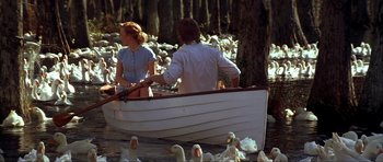 Movie still from “The Notebook” (2004), directed by Nick Cassavetes – A man and a woman are in a row boat; Wide shot, High angle