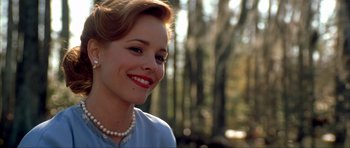 Movie still from “The Notebook” (2004), directed by Nick Cassavetes – A woman wearing a pearl necklace smiling for the camera; Close Up shot, Over the shoulder angle
