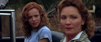 Movie still from “The Notebook” (2004), directed by Nick Cassavetes – Two women sitting next to each other in a field; Close Up shot, Over the shoulder angle