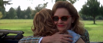 Movie still from “The Notebook” (2004), directed by Nick Cassavetes – A woman hugging another woman in a field; Close Up shot, Over the shoulder angle