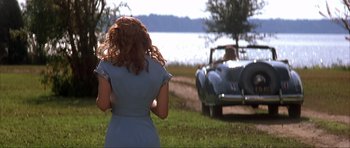 Movie still from “The Notebook” (2004), directed by Nick Cassavetes – A woman standing in front of a car on a field; Medium shot, Over the shoulder angle