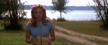 Movie still from “The Notebook” (2004), directed by Nick Cassavetes – A woman holding a stack of papers in a field; Medium shot, Over the shoulder angle