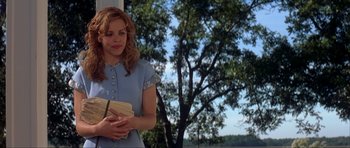 Movie still from “The Notebook” (2004), directed by Nick Cassavetes – A woman holding a book in her hands; Medium shot, Over the shoulder angle