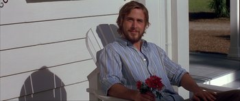 Movie still from “The Notebook” (2004), directed by Nick Cassavetes – A man sitting in a chair holding flowers; Medium shot, Over the shoulder angle