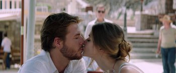 Movie still from “The November Man” (2014), directed by Roger Donaldson – A man and a woman kissing in front of another man; Close Up shot, Over the shoulder angle