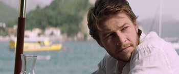 Movie still from “The November Man” (2014), directed by Roger Donaldson – A man's face near a body of water; Close Up shot, Over the shoulder angle