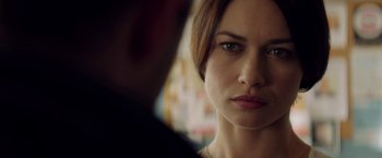 Movie still from “The November Man” (2014), directed by Roger Donaldson – A woman's face in front of a man; Close Up shot, Over the shoulder angle
